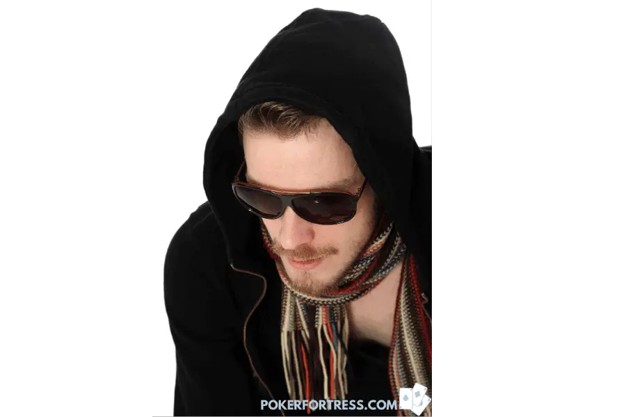 Poker player wear scarf, sunglasses and a hoodie.